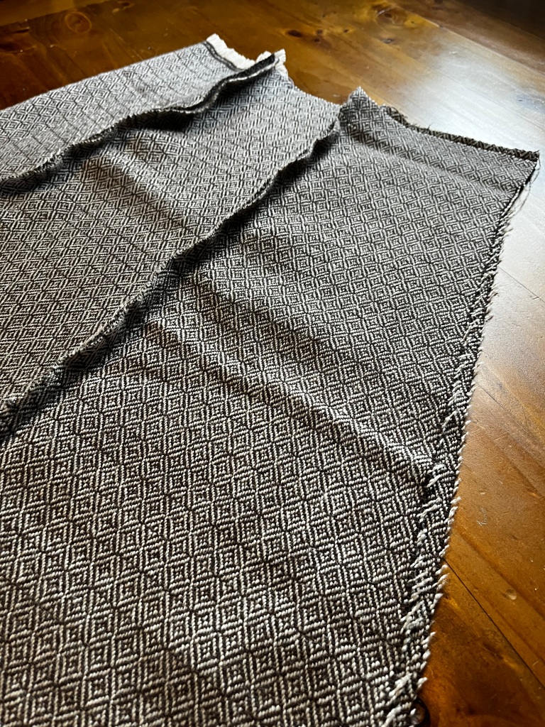 Picture showing garment with side seams sewn but not flat-felled. Centre back edges aligned but not sewn.